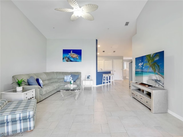 living room featuring ceiling fan and light tile patterned flooring