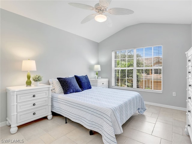 bedroom with ceiling fan, light tile patterned floors, and vaulted ceiling