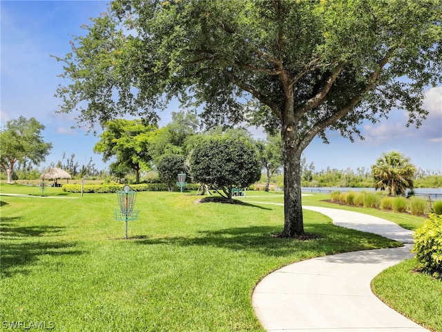 surrounding community with a yard and a water view