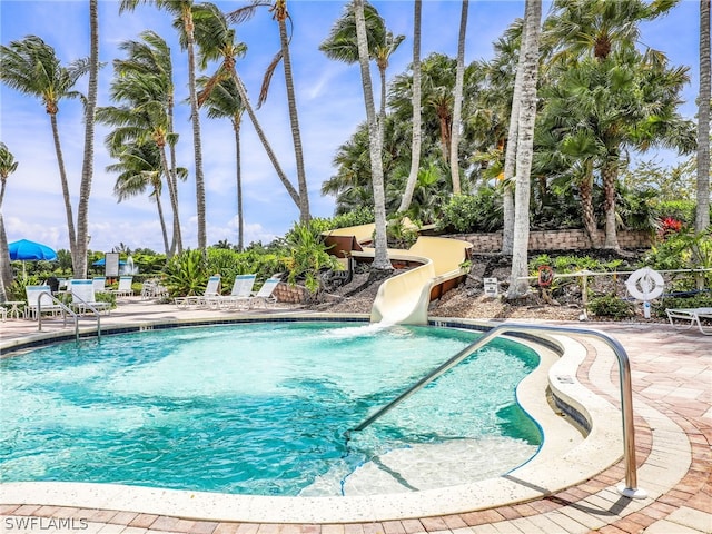 view of pool with a patio area and a water slide