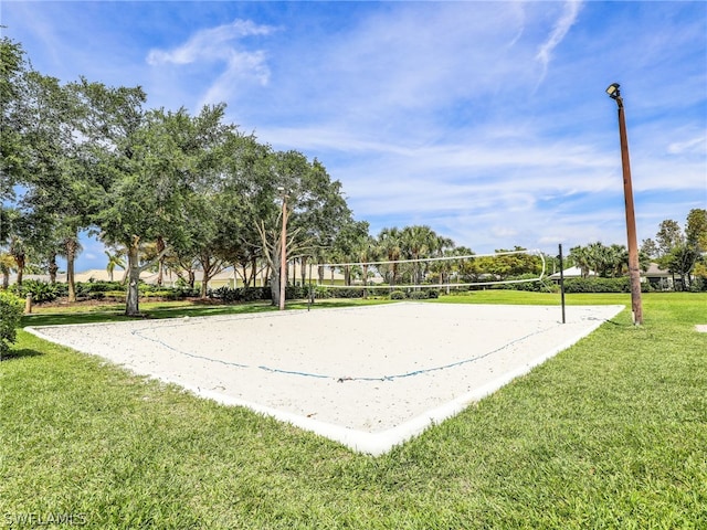 view of property's community with volleyball court and a yard