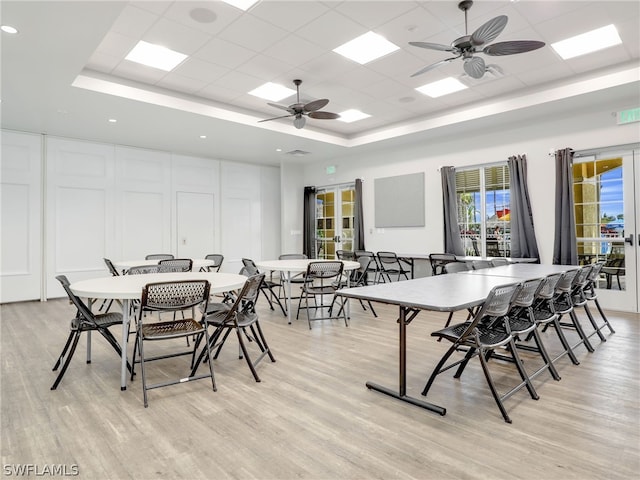 dining room featuring a paneled ceiling, ceiling fan, and light wood-type flooring