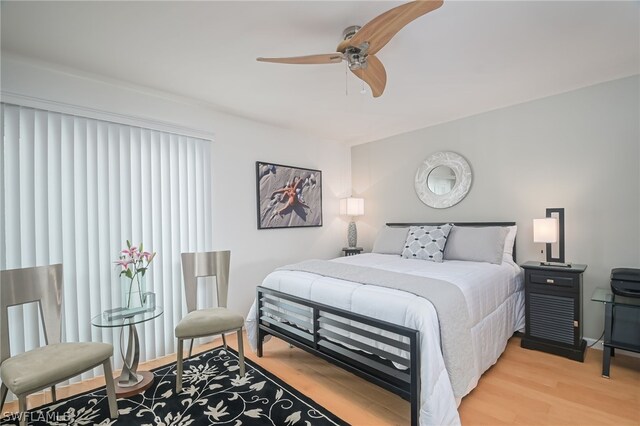 bedroom with hardwood / wood-style floors and ceiling fan