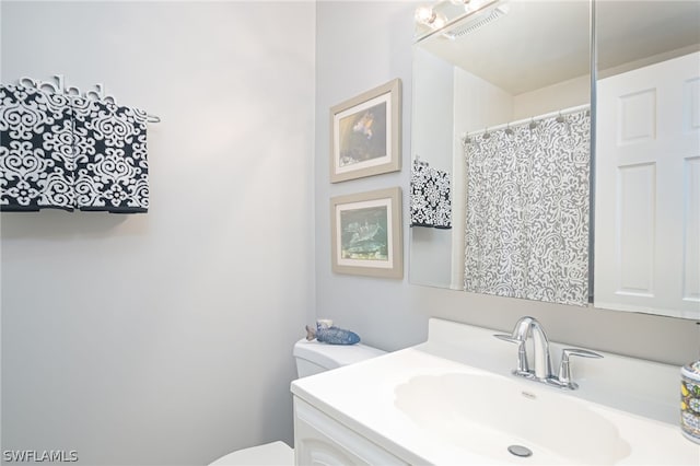 bathroom featuring vanity and toilet