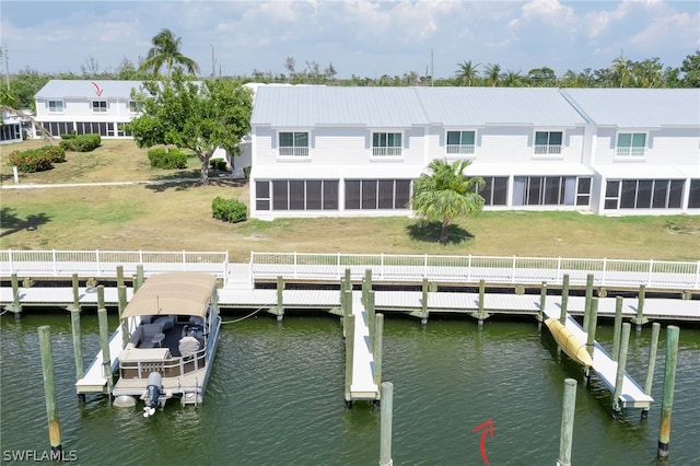 back of property featuring a yard and a water view