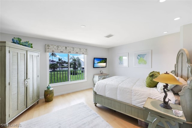 bedroom with light wood-type flooring and a closet