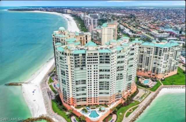 birds eye view of property featuring a view of the beach and a water view