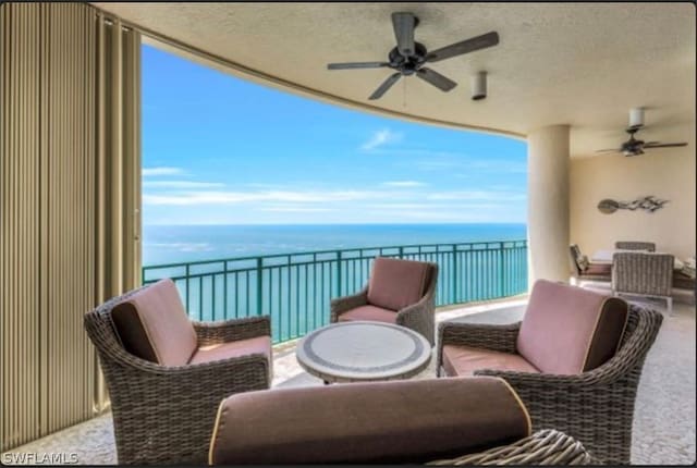 balcony with ceiling fan, outdoor lounge area, and a water view