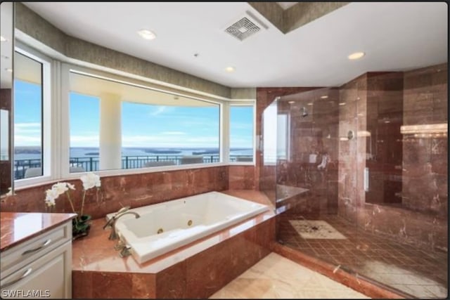 bathroom featuring tile floors, separate shower and tub, vanity, and a water view