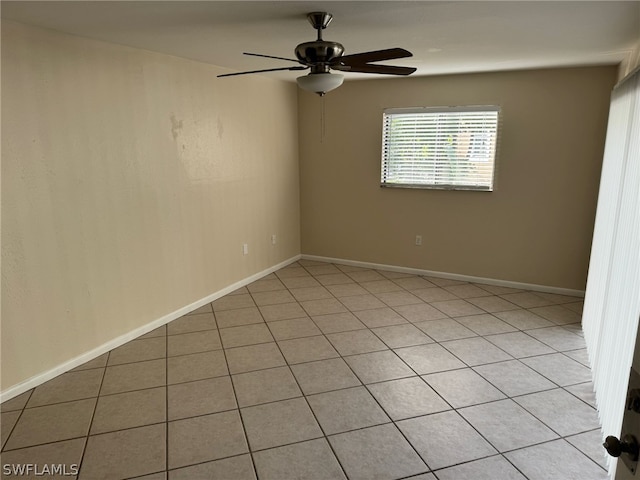 unfurnished room with ceiling fan and light tile floors