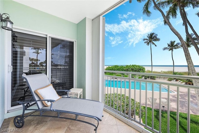 sunroom featuring a water view