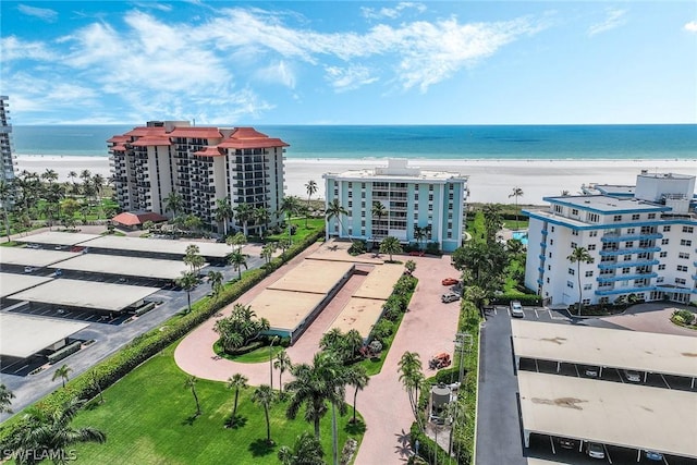 birds eye view of property with a view of the beach and a water view