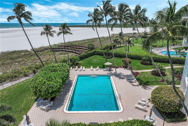 view of swimming pool with a patio and a water view