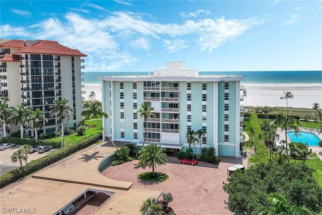 view of building exterior featuring a view of the beach and a water view