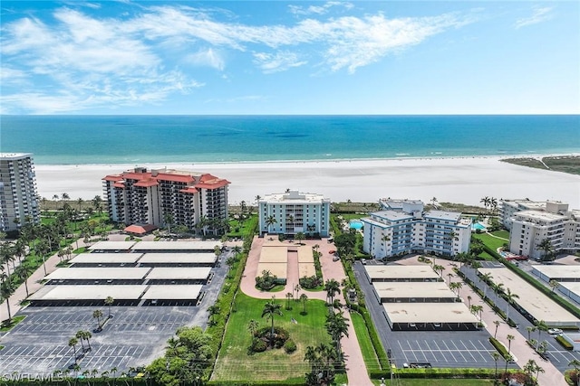 birds eye view of property featuring a view of the beach and a water view