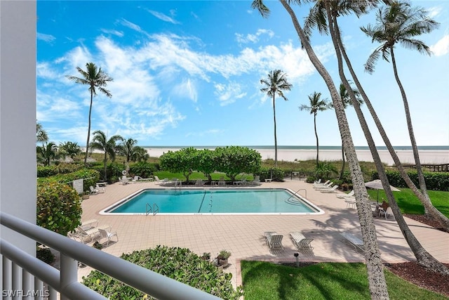 view of pool featuring a patio area and a water view