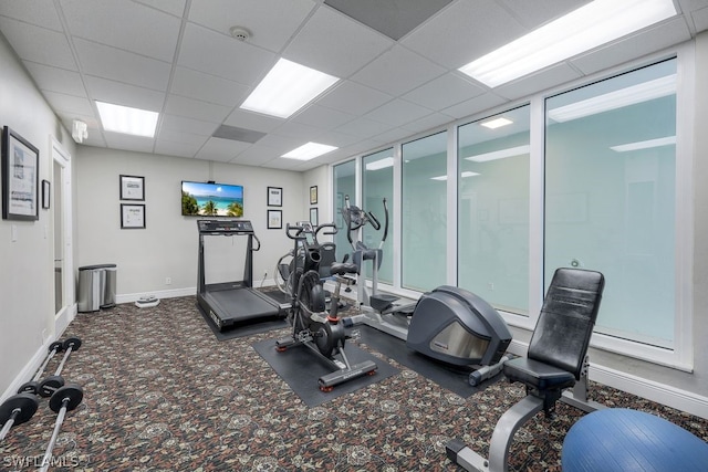 gym with carpet floors and a drop ceiling