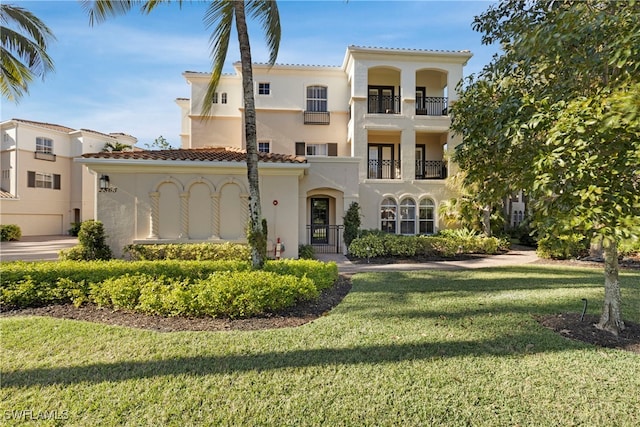 mediterranean / spanish-style house with a front lawn