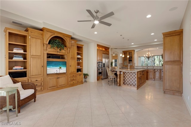 living room featuring ceiling fan with notable chandelier and light tile patterned floors