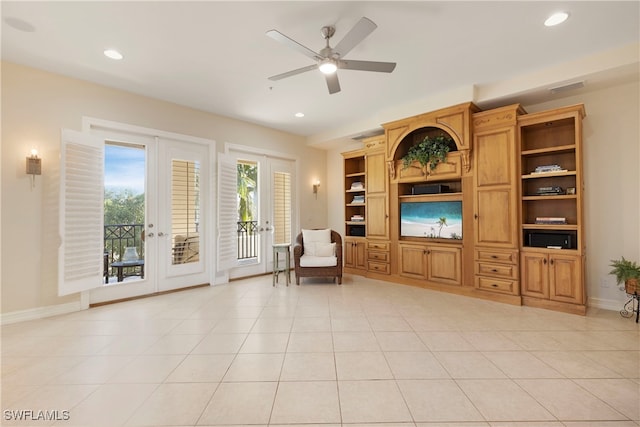 sitting room featuring french doors, light tile patterned floors, ceiling fan, and built in shelves