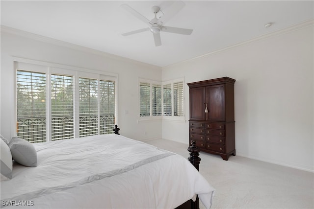 carpeted bedroom featuring multiple windows, ceiling fan, and ornamental molding