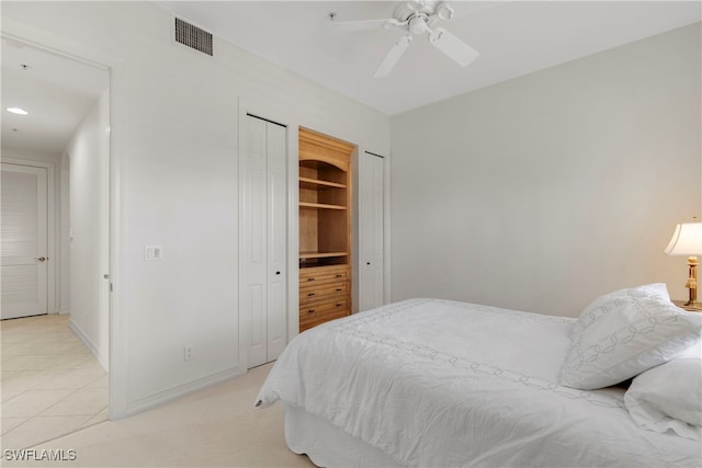 tiled bedroom featuring ceiling fan