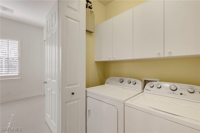 laundry room with cabinets and separate washer and dryer