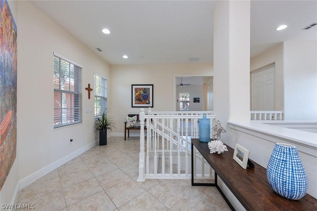 hall with light tile patterned floors