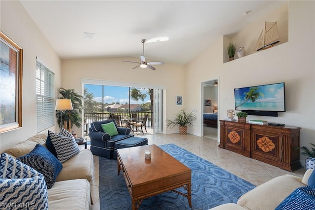 living room featuring ceiling fan, plenty of natural light, light tile patterned flooring, and lofted ceiling