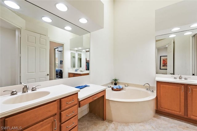 bathroom featuring tile patterned floors, a tub, and vanity