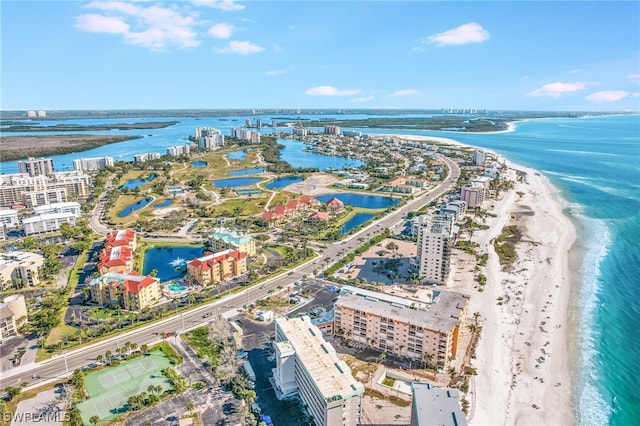 drone / aerial view featuring a beach view and a water view