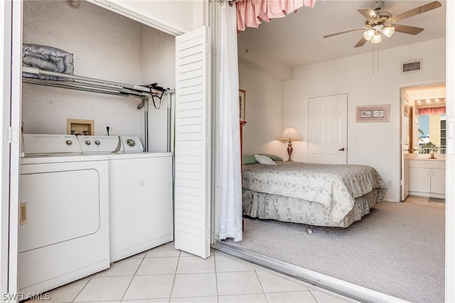 clothes washing area with hookup for a washing machine, ceiling fan, washer and clothes dryer, and light tile flooring