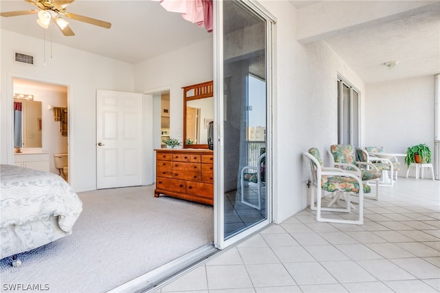 carpeted bedroom with access to outside, ceiling fan, and ensuite bath