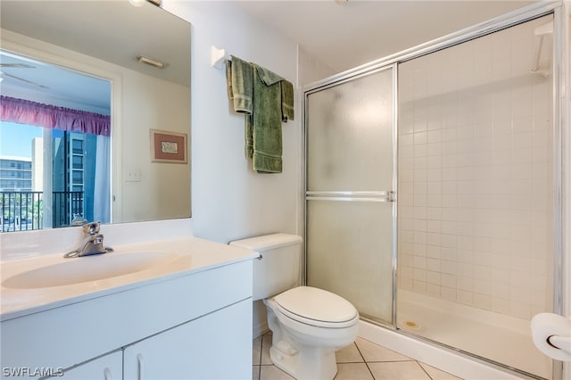 bathroom featuring a shower with shower door, oversized vanity, toilet, and tile floors