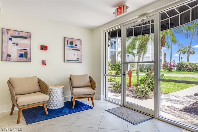 sitting room featuring light tile flooring and plenty of natural light