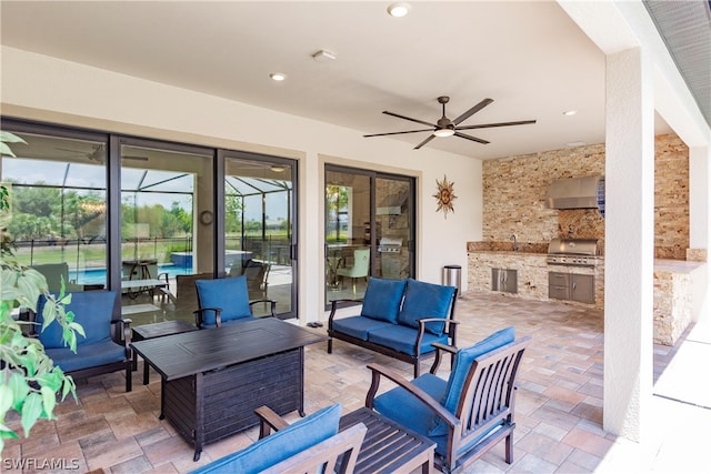 view of patio featuring grilling area, an outdoor kitchen, an outdoor hangout area, sink, and ceiling fan