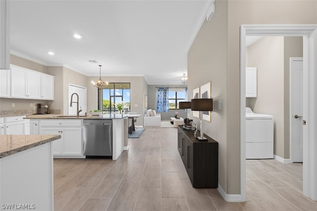 kitchen featuring a notable chandelier, a sink, white cabinets, open floor plan, and dishwasher