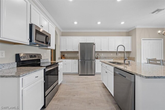 kitchen with appliances with stainless steel finishes, white cabinetry, a sink, and ornamental molding