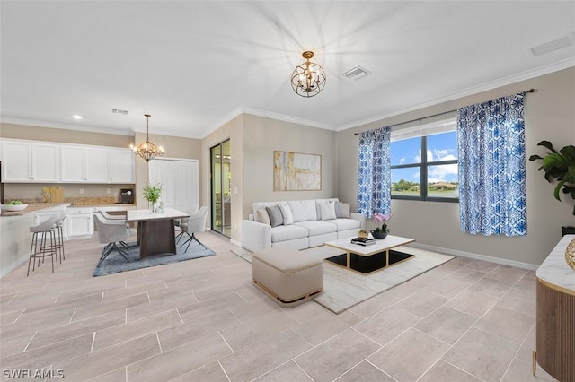 living area with visible vents, a chandelier, baseboards, and ornamental molding