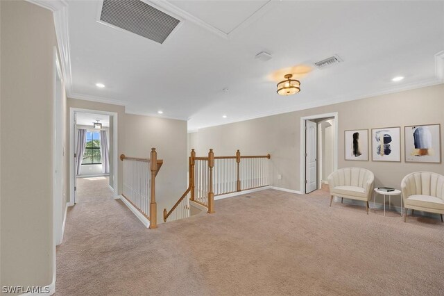 living area with carpet flooring, an upstairs landing, visible vents, baseboards, and ornamental molding