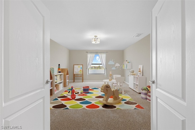 game room featuring carpet flooring, visible vents, and baseboards