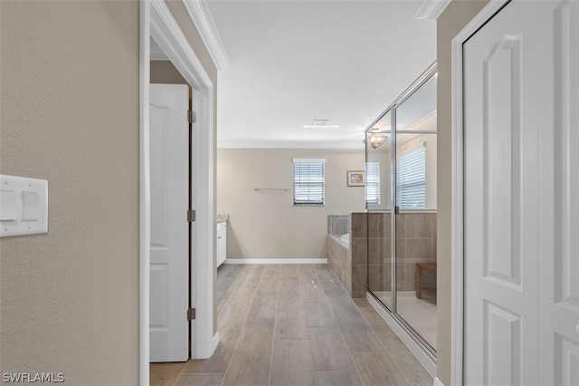 full bathroom with baseboards, a garden tub, wood tiled floor, an enclosed shower, and crown molding