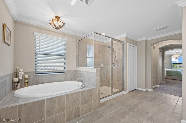 ensuite bathroom featuring a bath, a shower stall, and crown molding