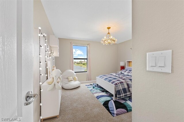 carpeted bedroom featuring a notable chandelier