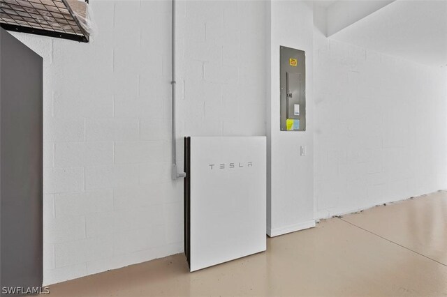 details with electric panel, finished concrete floors, and concrete block wall