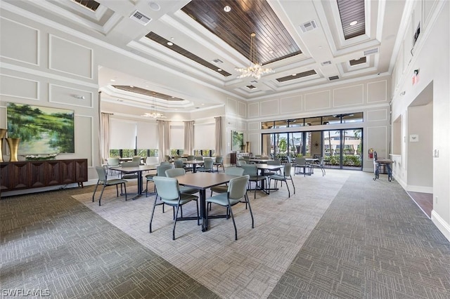 dining space with a chandelier, coffered ceiling, ornamental molding, and a towering ceiling