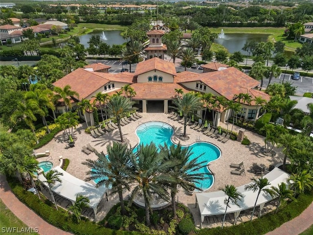 view of pool with a water view and a patio