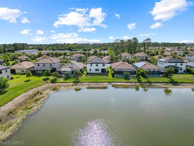 drone / aerial view with a residential view and a water view