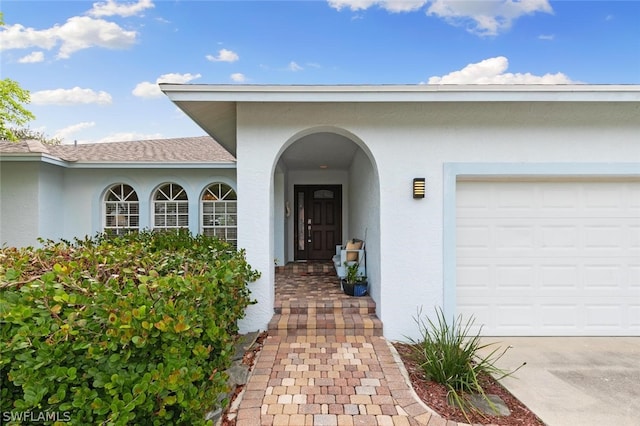 doorway to property with a garage