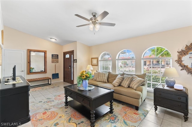 tiled living room with lofted ceiling and ceiling fan